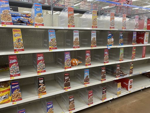 Empty shelves that should contain cereal at a grocery store. 