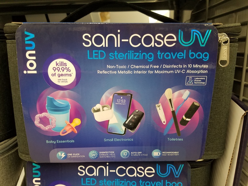 This is a picture of a UV LED light sterilizing travel case in its box. The box advertises that it can be used for "baby essentials, small electronics, and toiletries". 