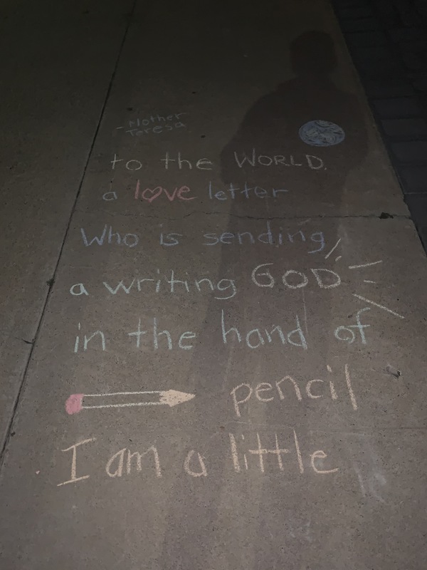 The words "I am a little pencil in the hands of a writing God, who is sending a love letter to the world. -Mother Teresa" written on a sidewalk in chalk. 