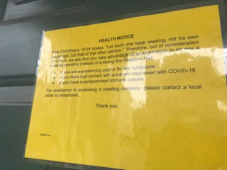 A yellow health notice sign.