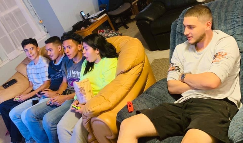Five people play video games. 