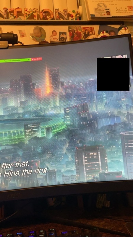 Computer screen showing digital city in a video game.  Upper right corner has black box, covering FaceTime image.