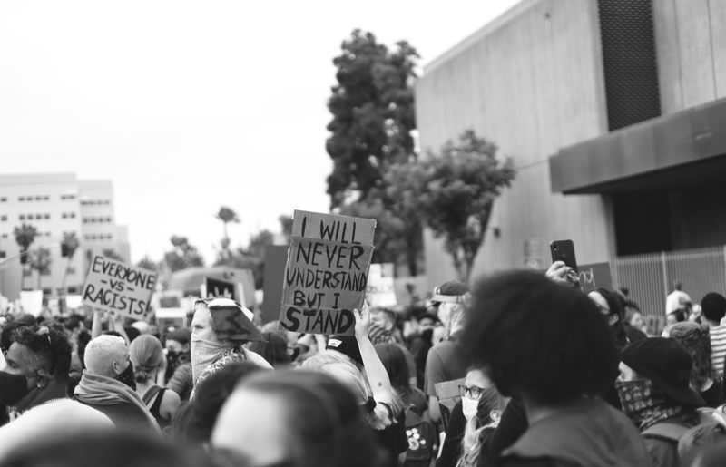 This is a black and white picture taken of a group of protesters that are demonstrating on behalf of the Black Lives Matter movement. 