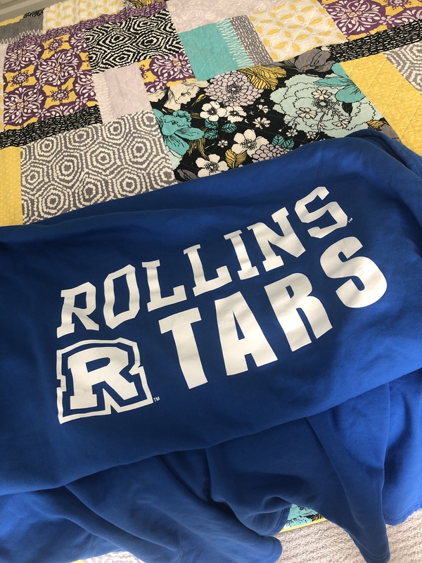 A blue blanket with the words "Rollins Tars" in white typeface. 