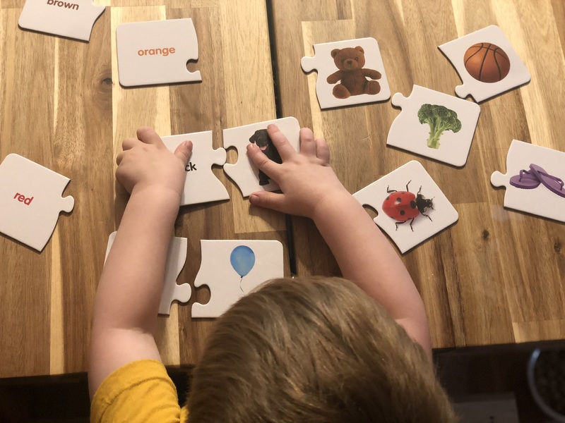 A child playing with puzzle pieces. 