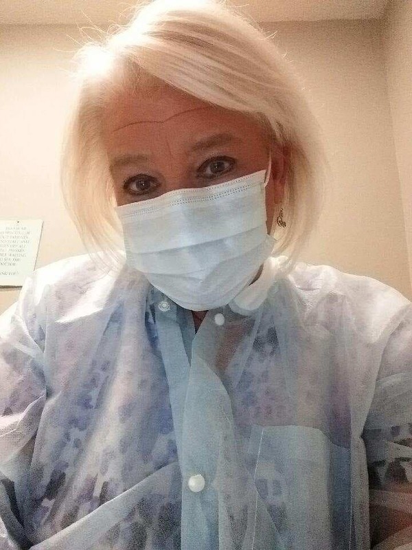 A female nurse wearing a face mask.