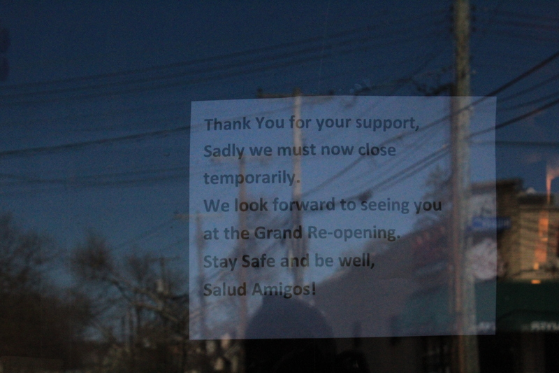 A sign in a window that says "Thank you for your support, Sadly we must now close temporarily. We look forward to seeing you at the Grand Re-opening. Stay safe and be well. Salud Amidos!"