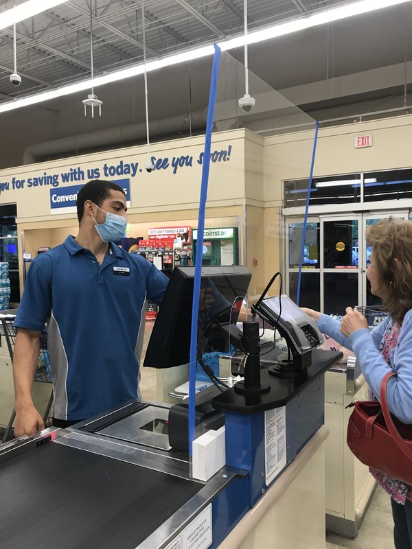 A cashier and a customer interacting. 