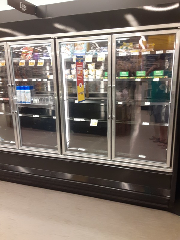 half empty fridges at a supermarket. 