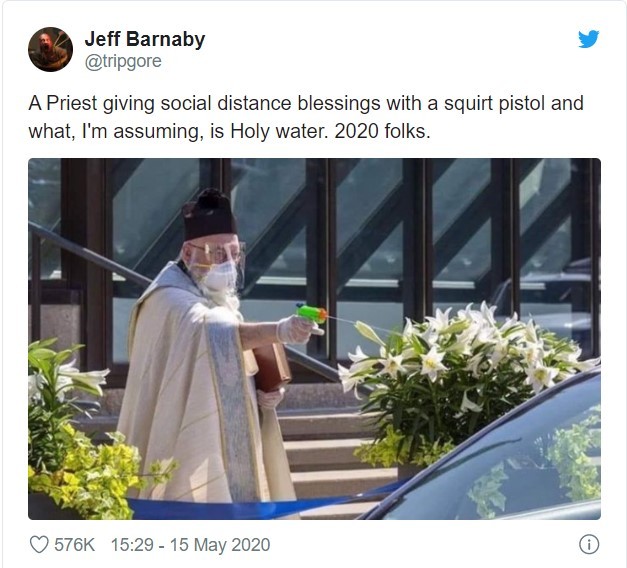 A screenshot of a tweet with a picture of a priest shooting water out of a squirt gun into a car.