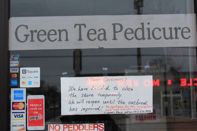 A handwritten sign at Green Tea Pedicure informing its customers that the salon will be closed temporarily; and will reopen once the outbreak improves.  