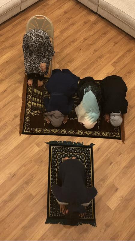 People praying on a mat. 