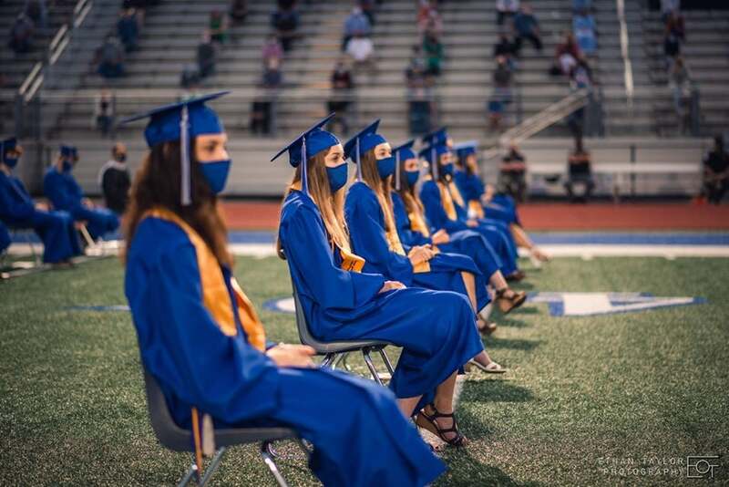 This is a picture taken of a socially distanced graduation ceremony. 