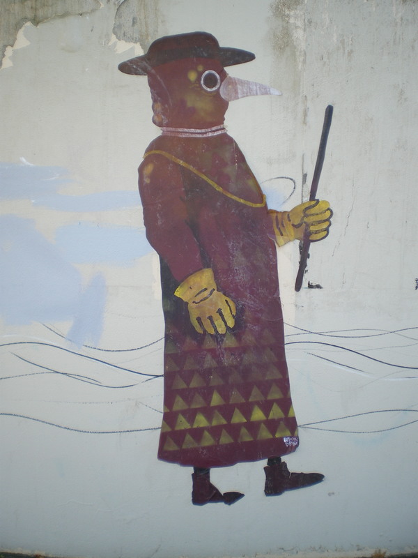A mural of a plague doctor. 