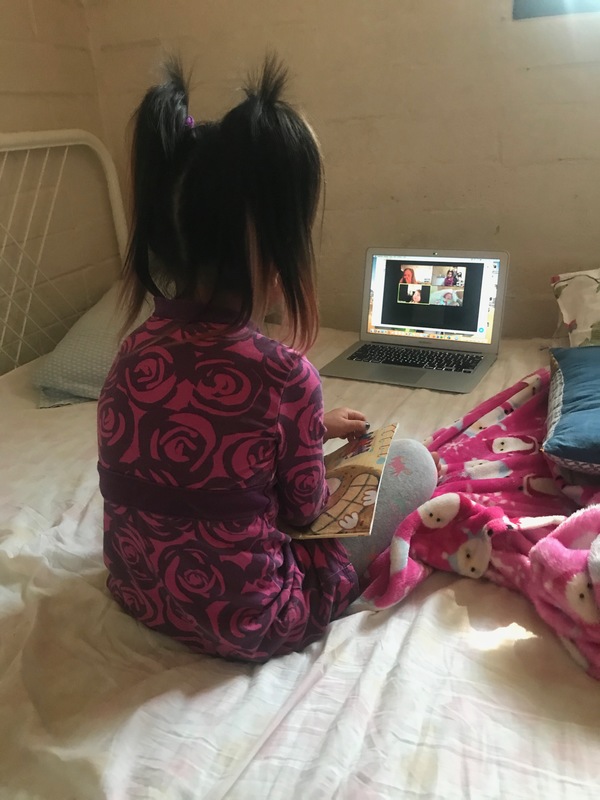 Picture of a young child on a Zoom call on a computer.