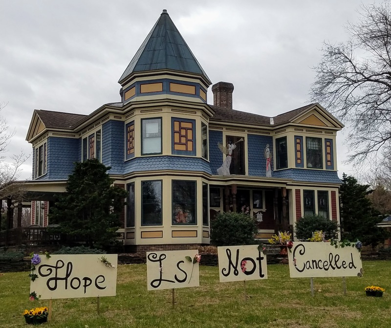 Signs that say "Hope is not cancelled" in front of a house. 