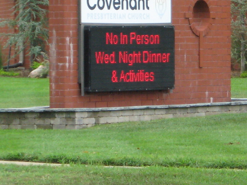 A LED sign outside a church reading No In Person Wed Night Dinner and Activities. 