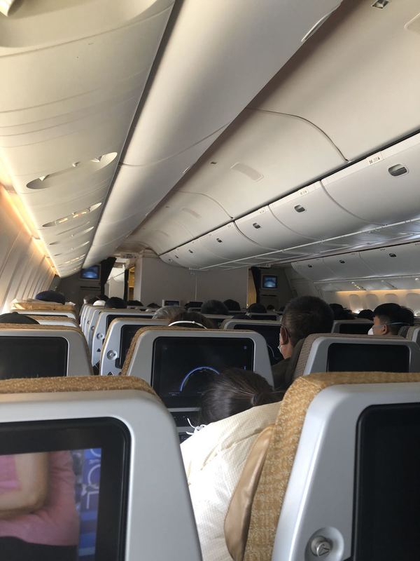 People seated in an airplane. 