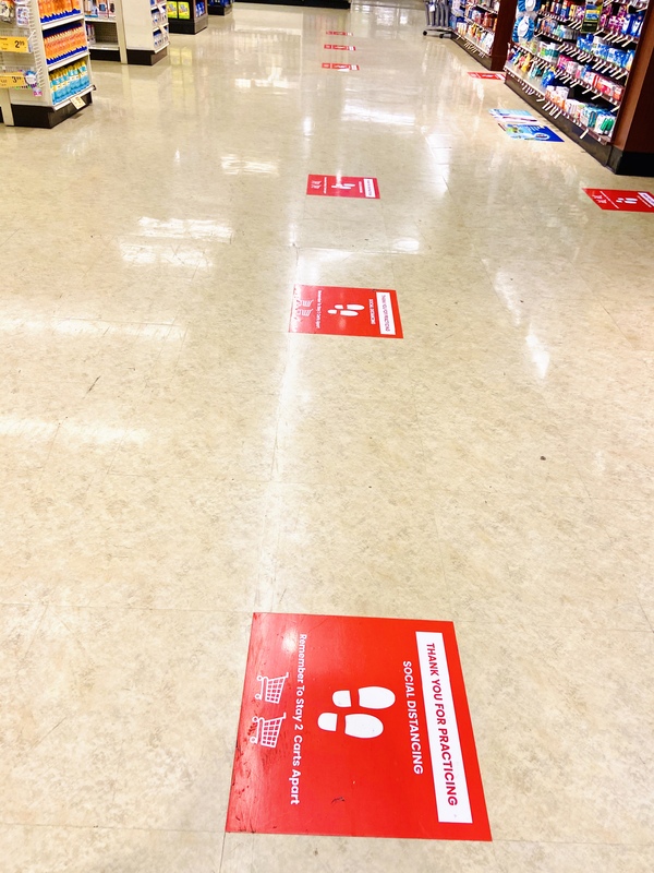 Social distancing signs on the floor. 