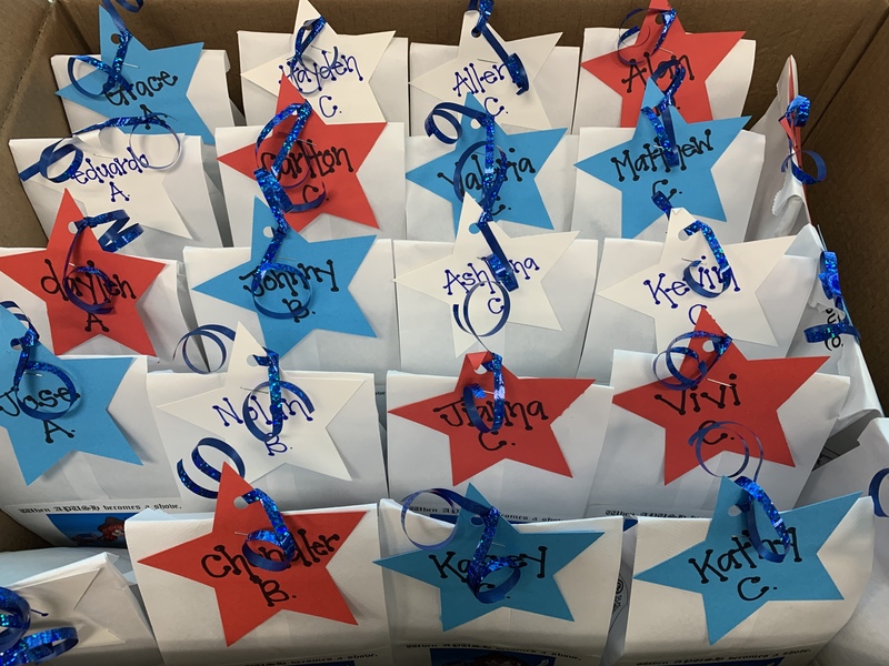 This is a picture of a group of gift bags with red, white, and blue tags on them. 