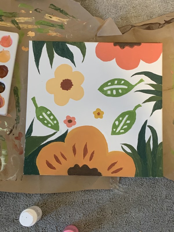 A painting of flowers and leaves.