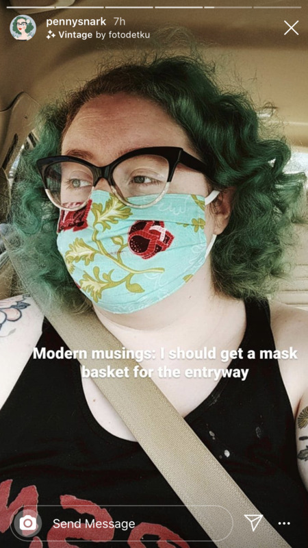A screenshot of a social media post featuring a woman wearing a mask. The words on the picture reads "modern musings: I should get a mask basket for the entry way".