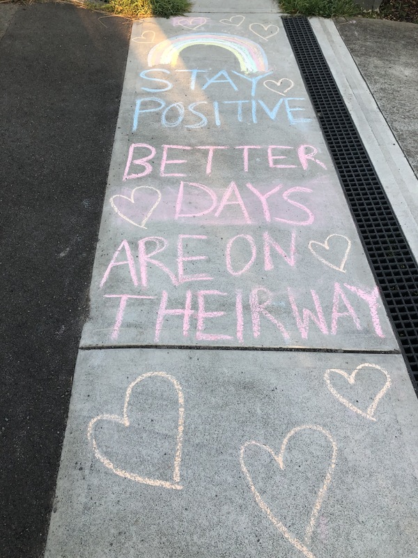 Message written in chalk on the sidewalk. 