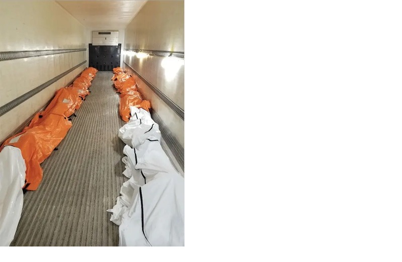 A hallway with tarps covering the deceased. 