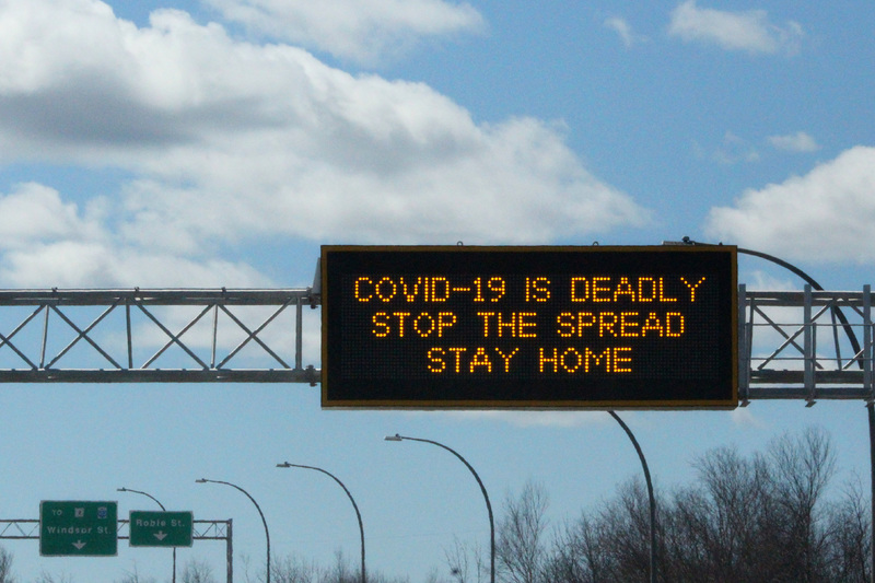 A highway sign that says "COVID-19 is deadly, stop the spread, stay home". 