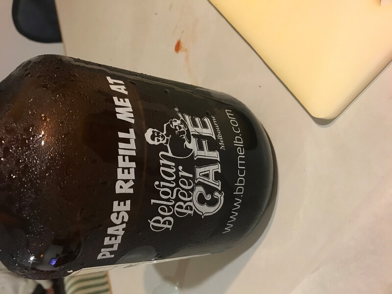The front of a bottle of beer that reads "Please refill me at Belgian Beer Cafe". 