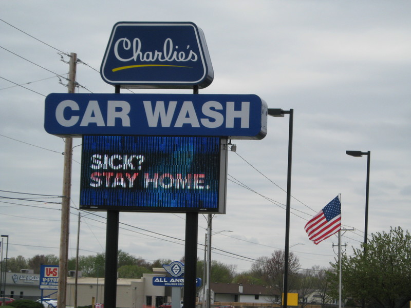 Image of a car wash business sign which reads Sick? Stay home.