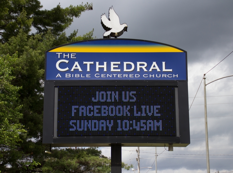 A sign outside The Cathedral: A Bible Centered Church reading "Join us. Facebook Live Sunday 10:45 am".