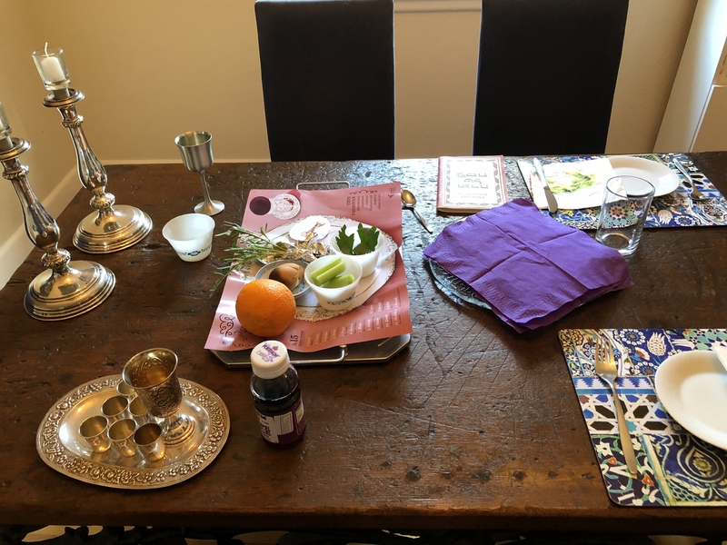 A photograph of a seder dinner for two people. 