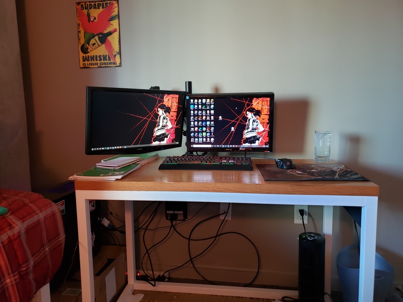 Two monitors on a desk. 