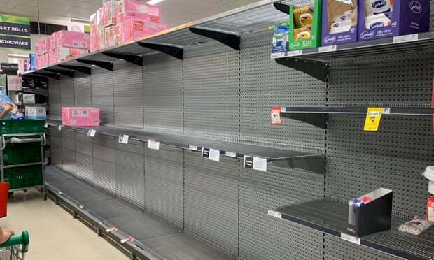 This is a picture taken of mostly empty shelves at a grocery store. 