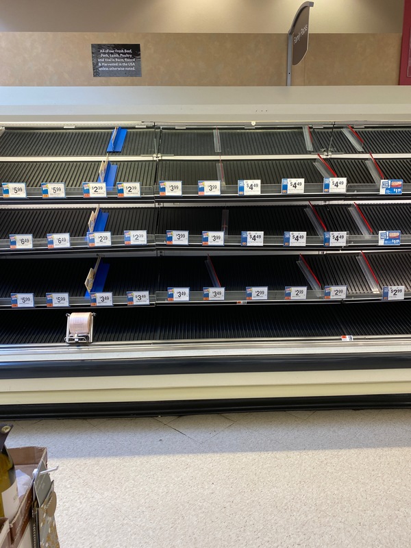 An empty meat section in a grocery store.