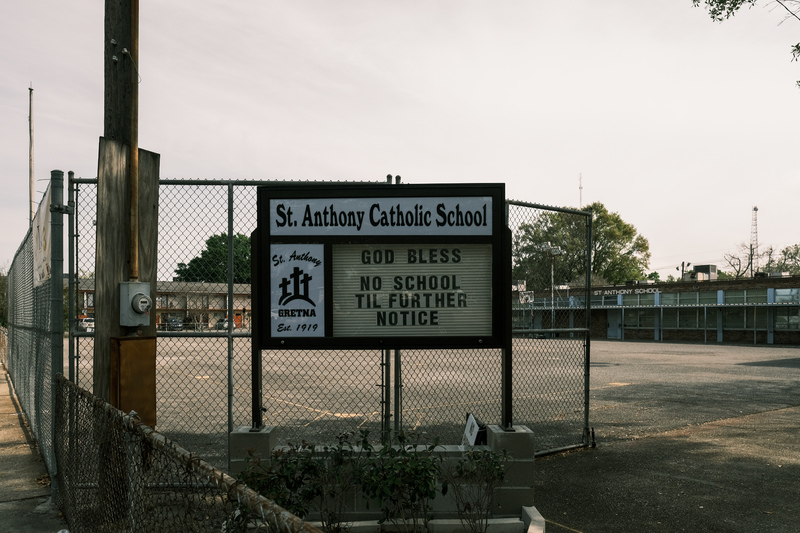 A sign in front of a school that says: "God Bless, no school until further notice."