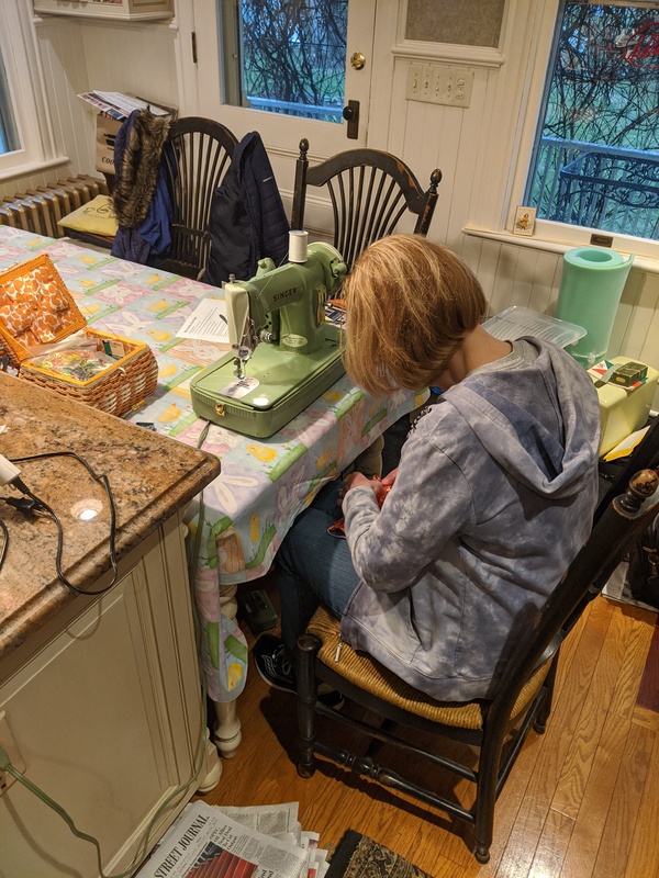 A person sewing and making face masks.