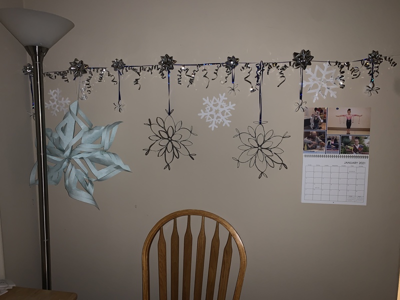 Paper snowflakes hanging on a wall.