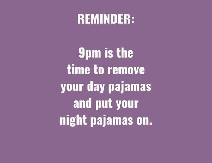 A purple sign that says: REMINDER: 9pm is the time to remove your day pajamas and put your night pajamas on. 