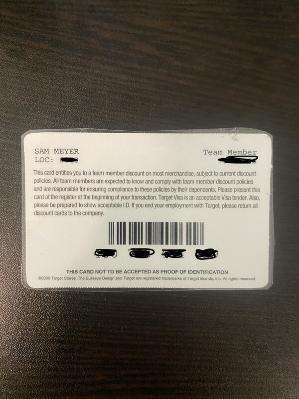 Back of Target Team Member discount card on wooden table.