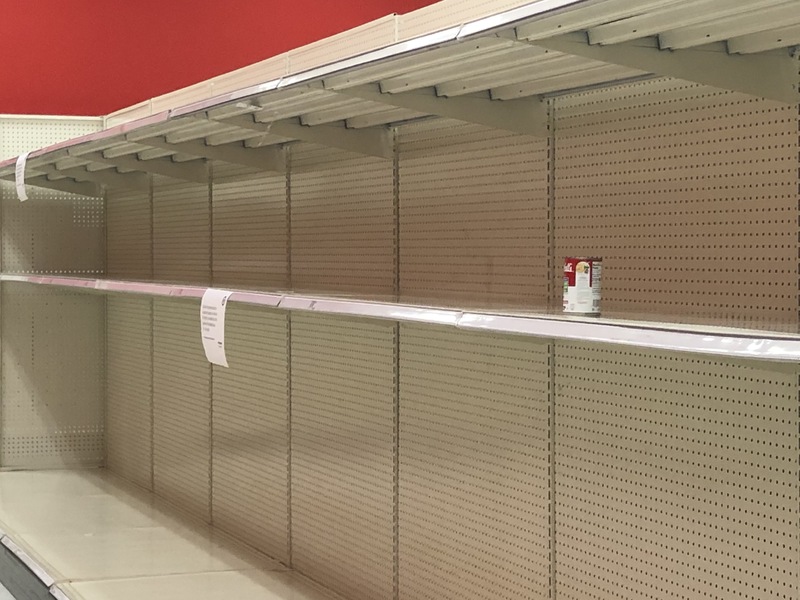 White empty shelves are shown with a can of campbell's sitting on the shelf. 