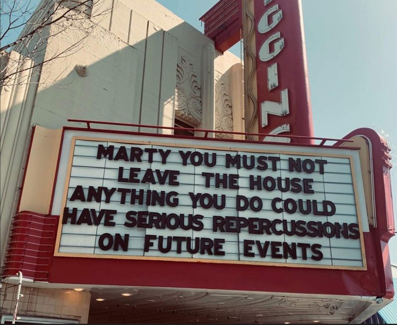 Image of a board outside of a movie theater, referencing Back to the Future, which reads Marty, you must not leave the house anything you do could have serious repercussions on future events.