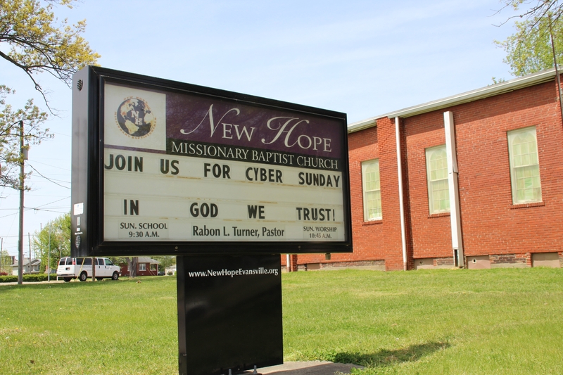 Photo of a sign outside New Hope Missionary Baptist Church reading "join us for cyber Sunday. In God we trust"