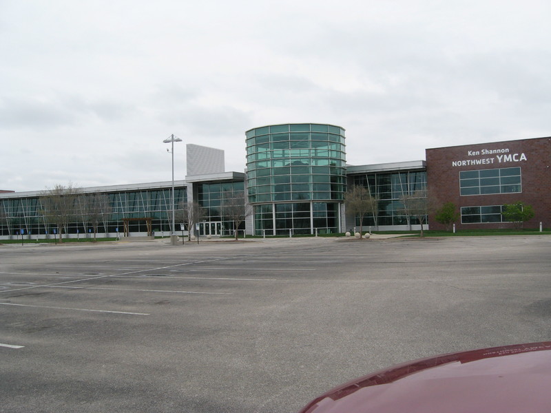 Image of an empty parking lot outside of a YMCA.