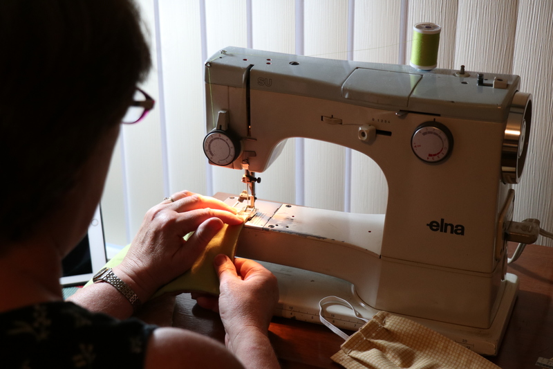 A person sewing. 