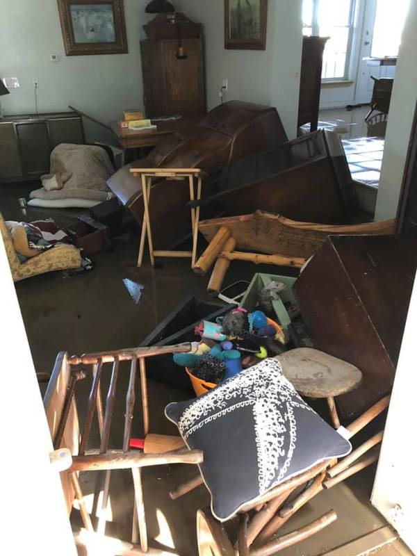 Image of a cluttered living room as a result of a recent flood.