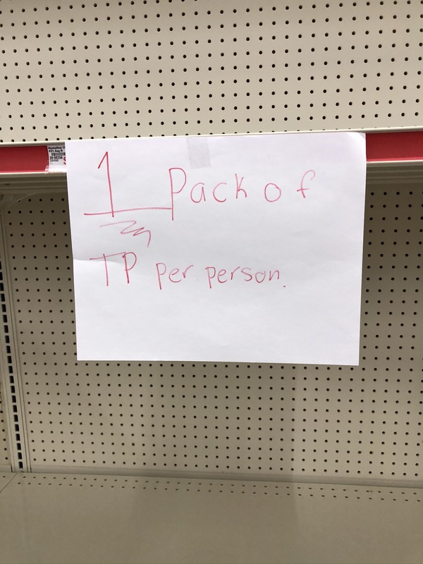 Sign taped to a store shelf that says "1 pack of TP per person."