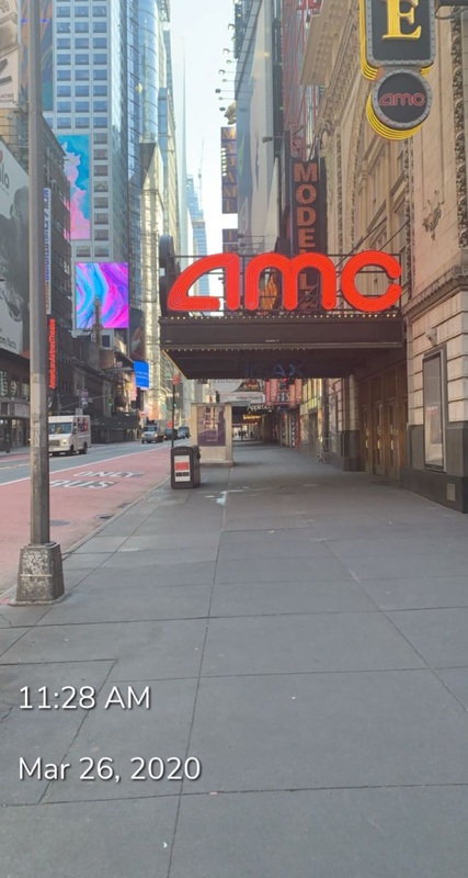 This is a photo taken from the street showing the entrance to an AMC Theater. This photo is time stamped 11:28 AM, March 26th, 2020.  
