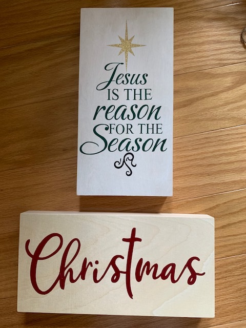 Two wooden signs reading Jesus is the Reason for the Season and Christmas.